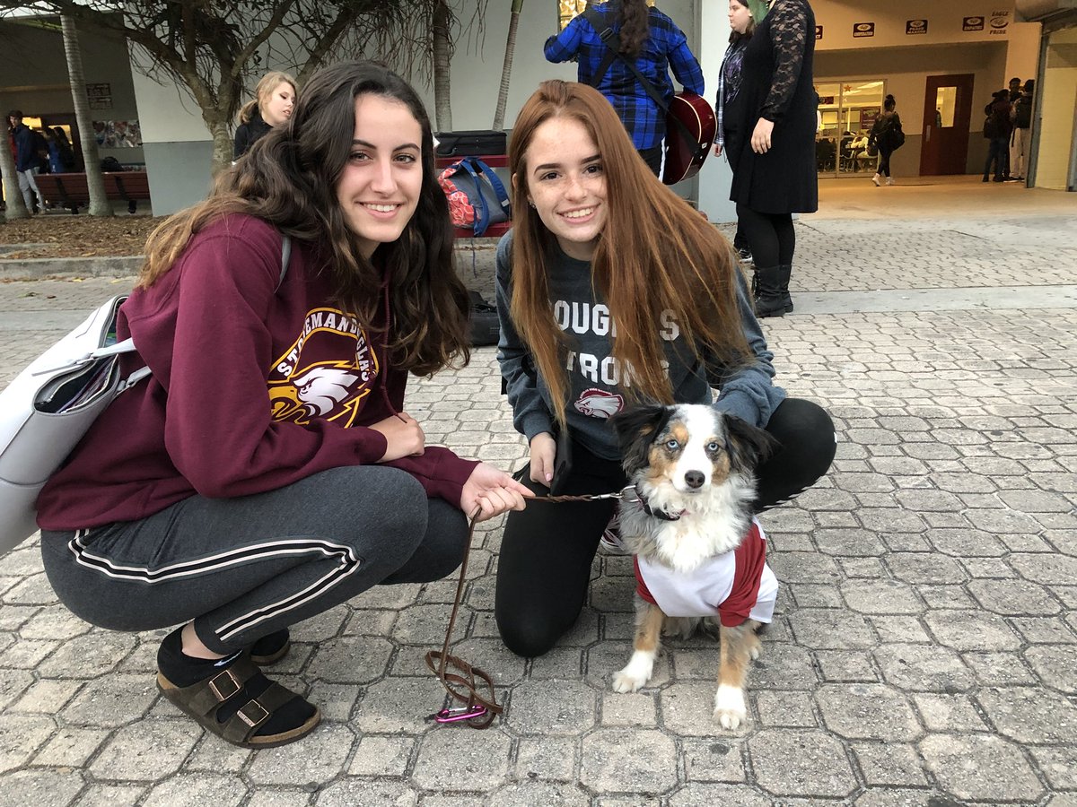 Therapy dog Karma with her pal @meganhall2222 and new friend supporting the students during their walk out and #onemonth #MSDStrong #schoolwalkout #solidarity #humanebroward #therapydogs #eaglepride #neveragain #NationalWalkoutDay #douglashighschool #StrongerTogether