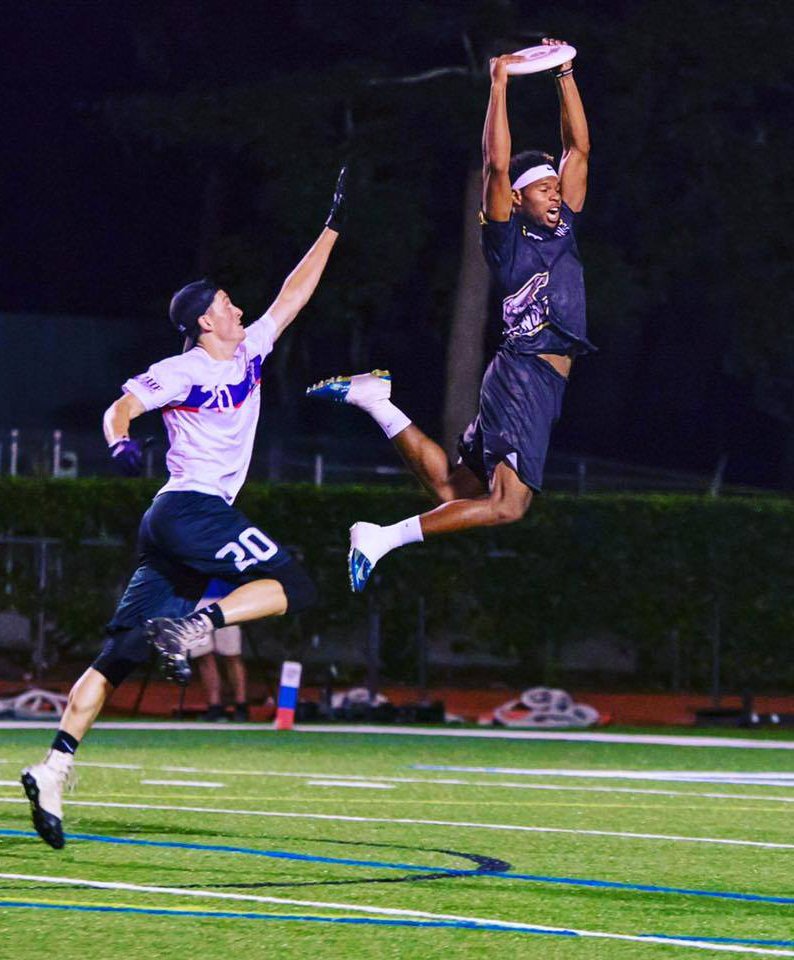 Just a couple of guys playing frisbee.