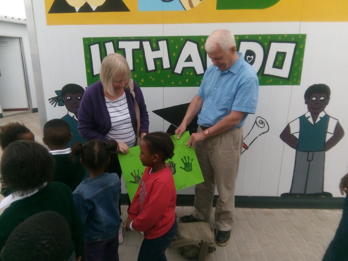 UthandoSouthAfr's tweet photo. Phil and Margo Harding from London receiving a Thank you hand painted poster from #IminathiEducare kids @THOKOZANIBROTHE  for their contribution donations that helped build the centre. #UthandoTours #ResponsibleTourism #FairTrade @Maseko_X #DoGood #AddPositivity @becausexm https://t.co/kzOgbwmKUf