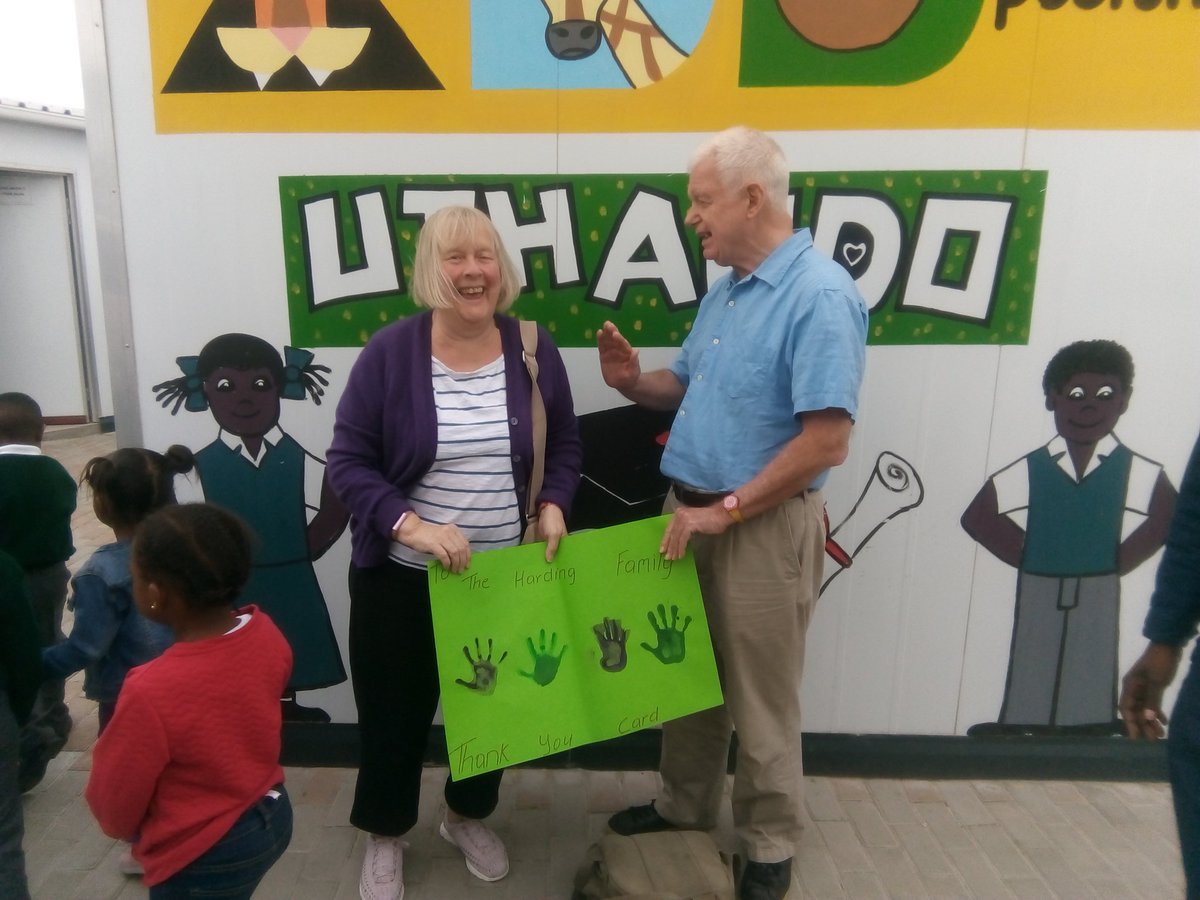 UthandoSouthAfr's tweet photo. Phil and Margo Harding from London receiving a Thank you hand painted poster from #IminathiEducare kids @THOKOZANIBROTHE  for their contribution donations that helped build the centre. #UthandoTours #ResponsibleTourism #FairTrade @Maseko_X #DoGood #AddPositivity @becausexm https://t.co/kzOgbwmKUf