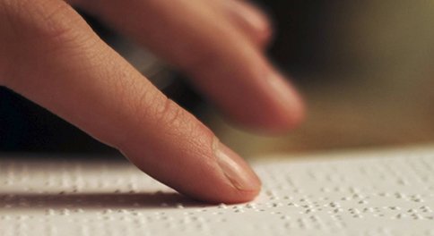 Person reading Braille text; image CC-BY-NC-ND by Dominique Archambault