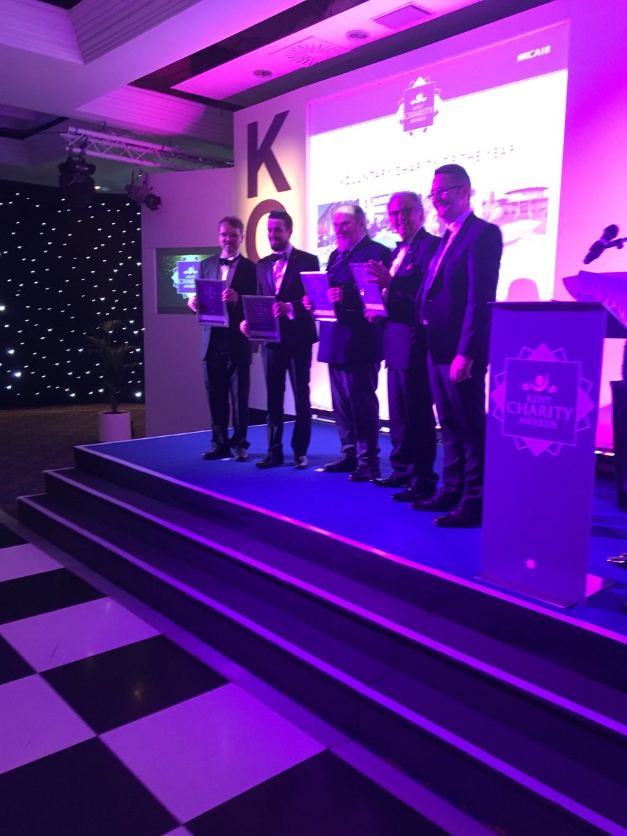 Simon Cook from <a href="/MidKentCollege/">MidKent College</a> takes to the stage to present the next certificates. Voluntary Charity #kca18 <a href="/CompaidTW/">Compaid</a>  and <a href="/Memorial_theFew/">The Battle of Britain Memorial</a> <a href="/broadietownshed/">Shedders</a> <a href="/TheFamilyTrust/">The Family Trust</a>