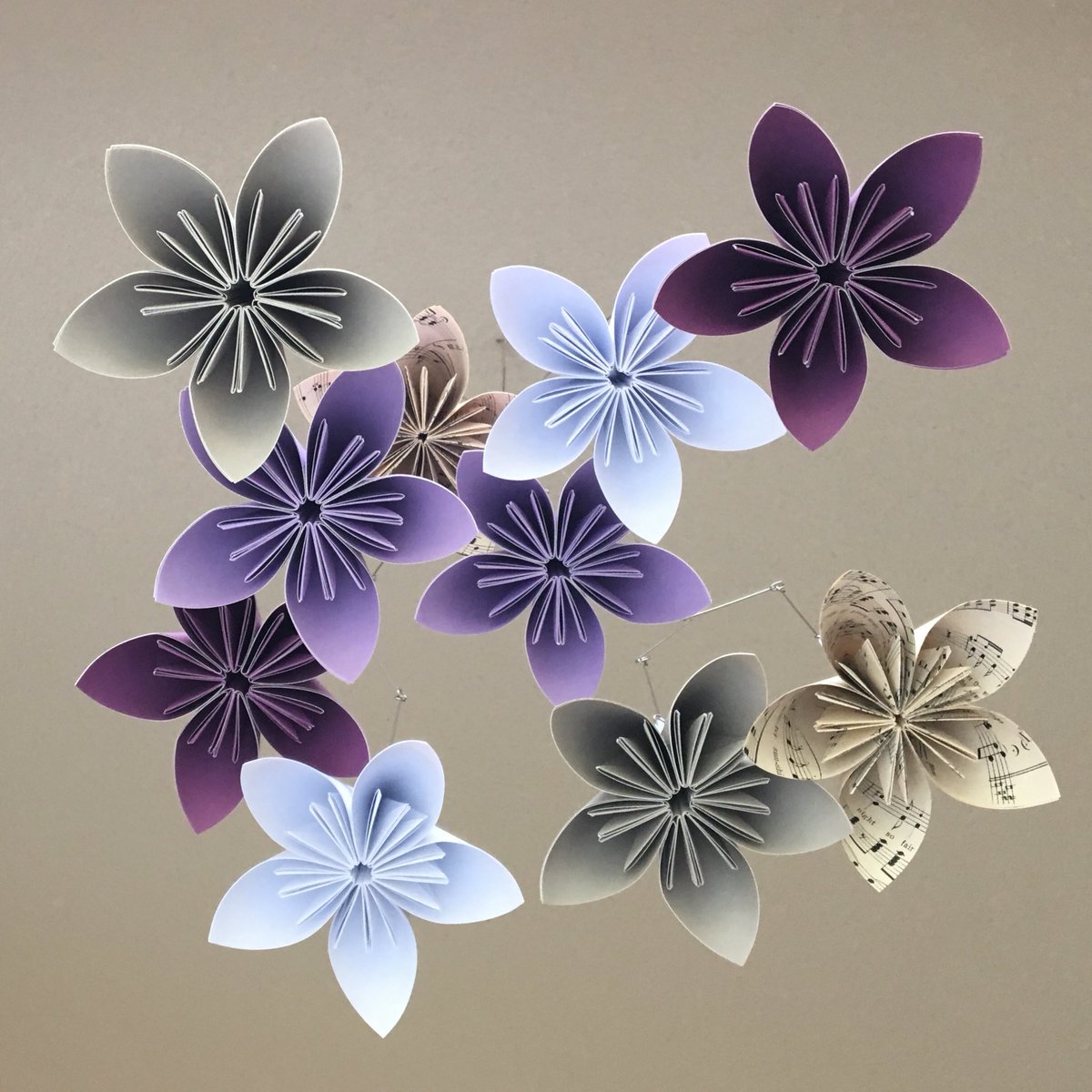katieaparker's tweet photo. Vintage sheet music, shades of purple & grey and white make this custom origami flower mobile a beautiful addition to a room. #katiemadeorigami #flowermobile #babymobile #nurserydecor #origamiflowers #handmade #papermobile #homedecorideas https://t.co/eY0WeMHVVY