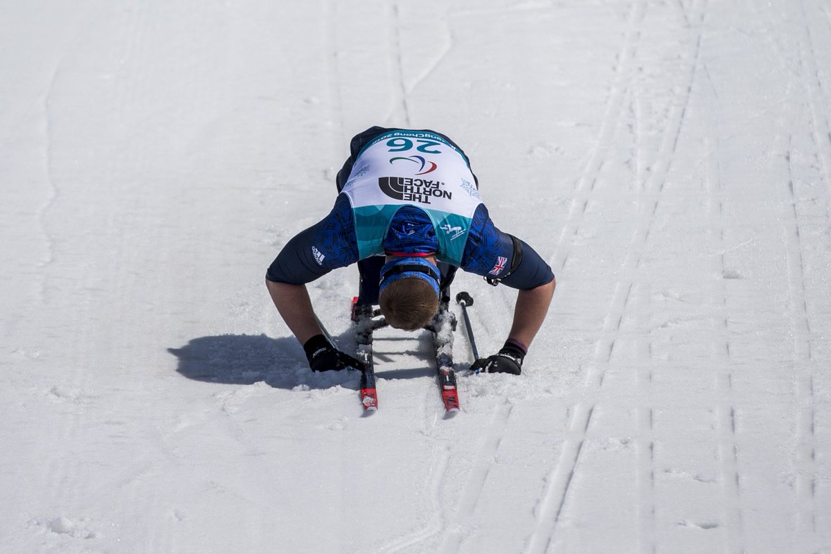 scott meenagh bows, spent, at the finish in the snow