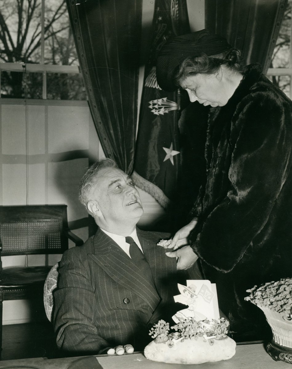 Happy #StPatricksDay and happy anniversary to Franklin and Eleanor! Here  Eleanor presents FDR with shamrocks on their 36th wedding anniversary in  1941., image size:949x1200