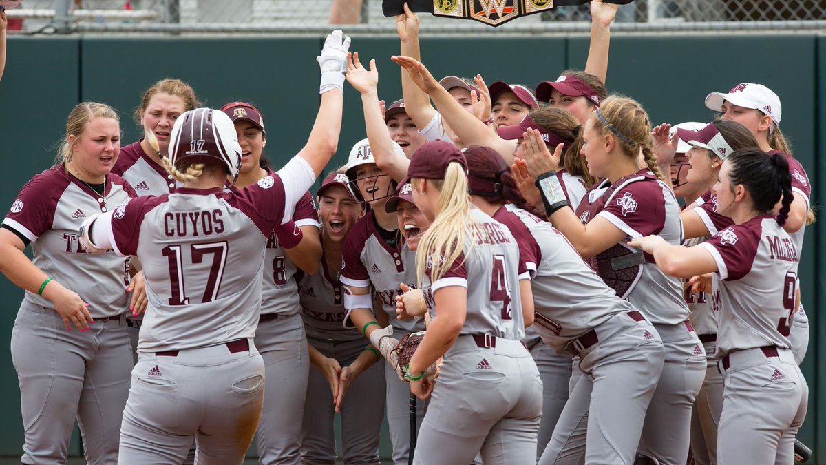 photo of aggie softball team celebrating at home plate