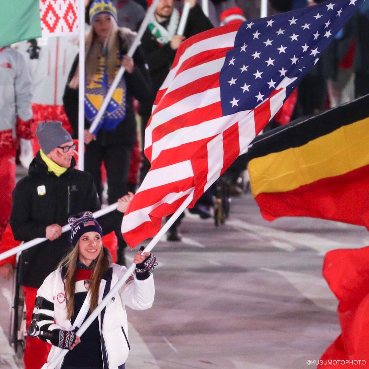 Oksana Masters carries the U.S. flag at the Winter Paralympics Closing Ceremony