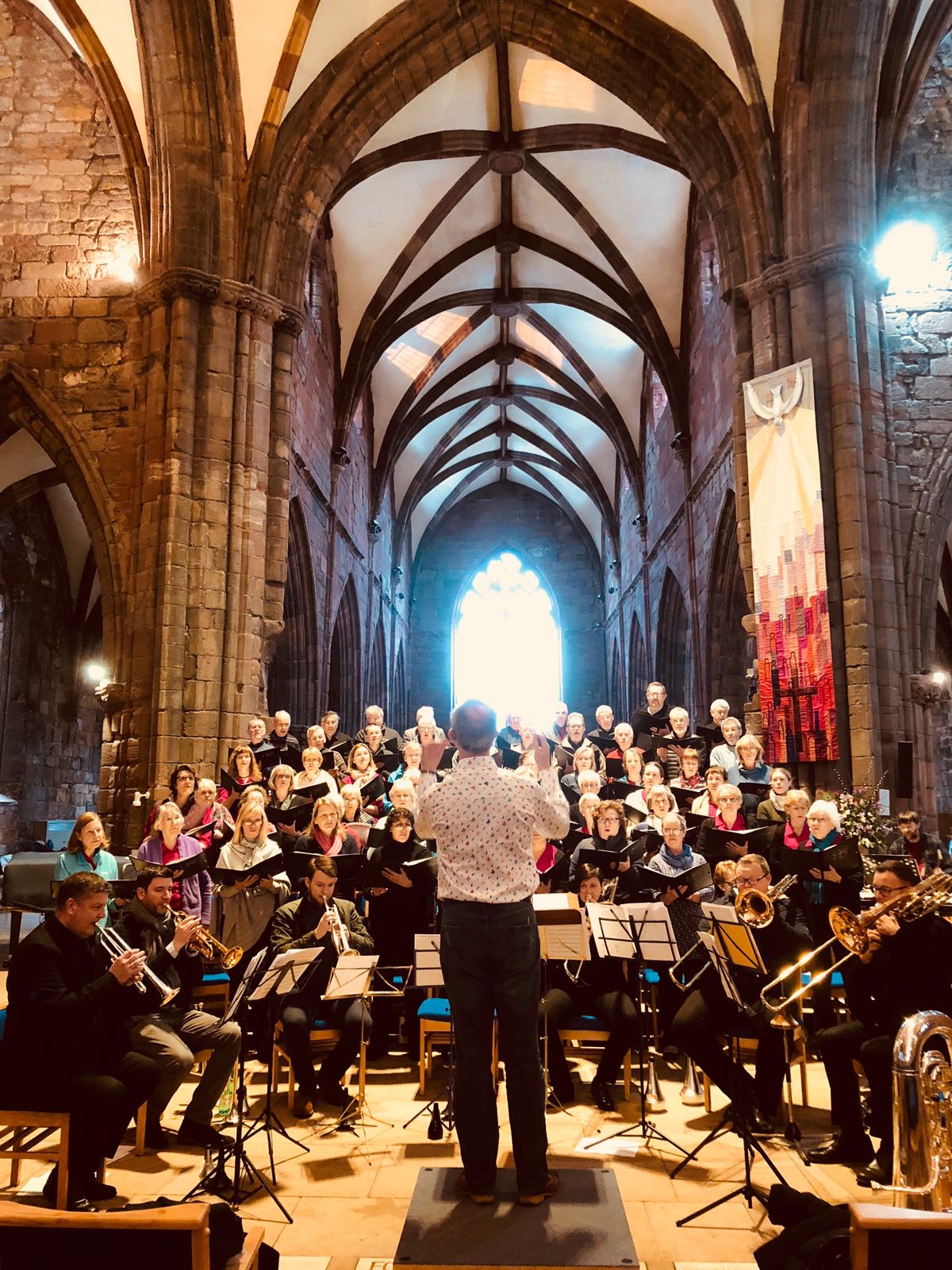 Brass Tracks Octet and choir rehearsing in St Mary's Kirk, Haddington