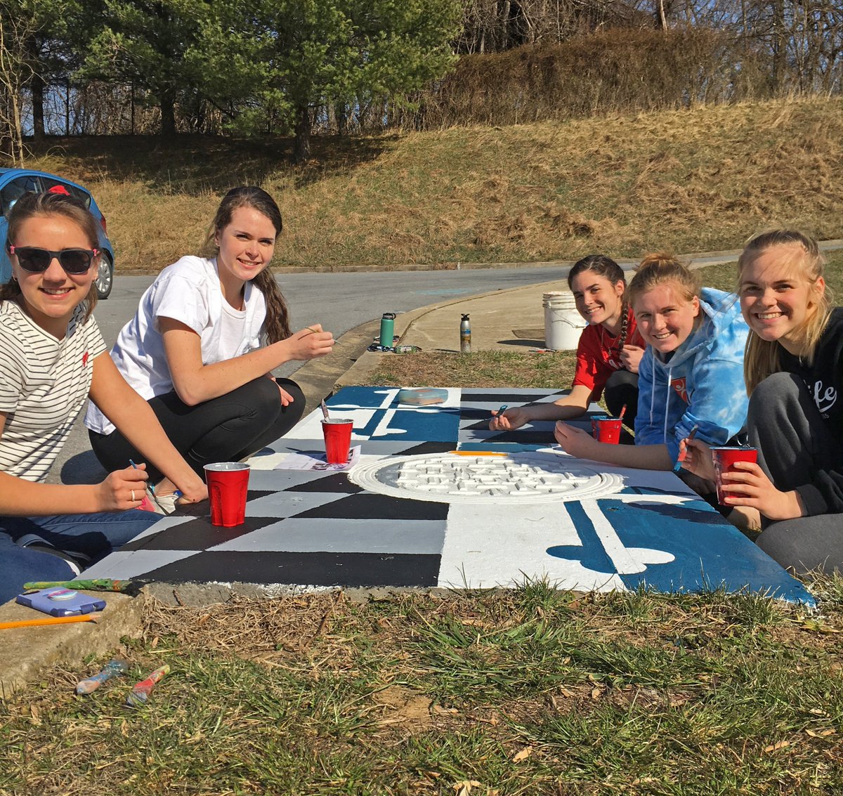 MyGreenMC's tweet photo. We love this solution to a local water quality issue! Today, students at #BlakeHighSchool painted a mural on a #storm drain on school property, decorating it with a design to #educate their peers about the #connection between storm drains and #local #water #quality! https://t.co/KedUyLOAn4