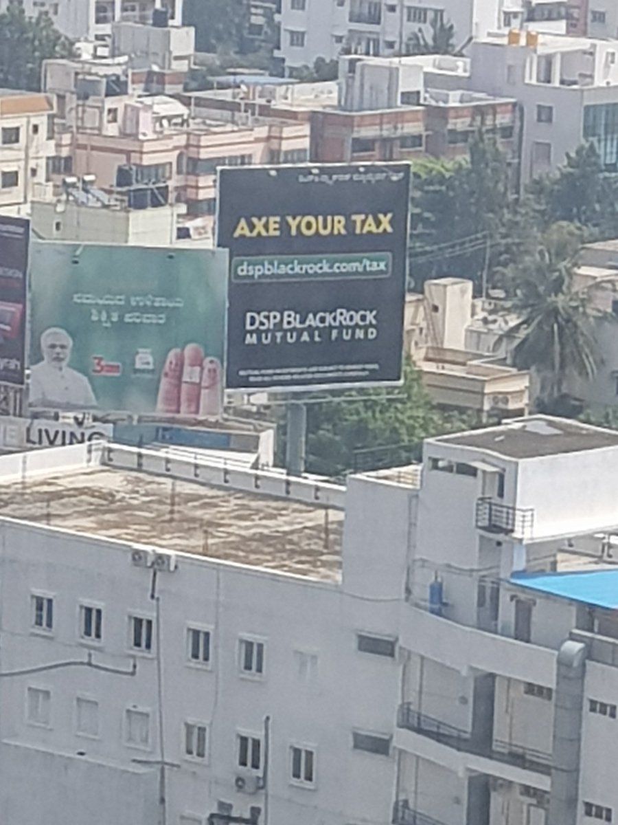 shwetanjain's tweet photo. When you don't even need to step out to spot this hoarding. Captured this from the balcony #AxedMyTax @dspbrmf @manishyennu https://t.co/s2ngWzptTZ