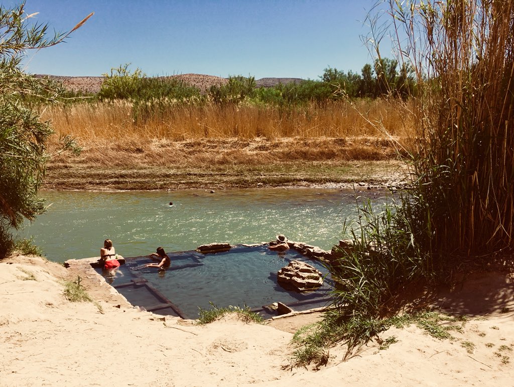NomadicJohn's tweet photo. Meanwhile down on that dangerous southern border, travelers who don’t buy into Faux News BS actually find peace and tranquility at the Big Bend hot springs. That deserted grassy knoll is Mexico. https://t.co/FY2C4EcugA