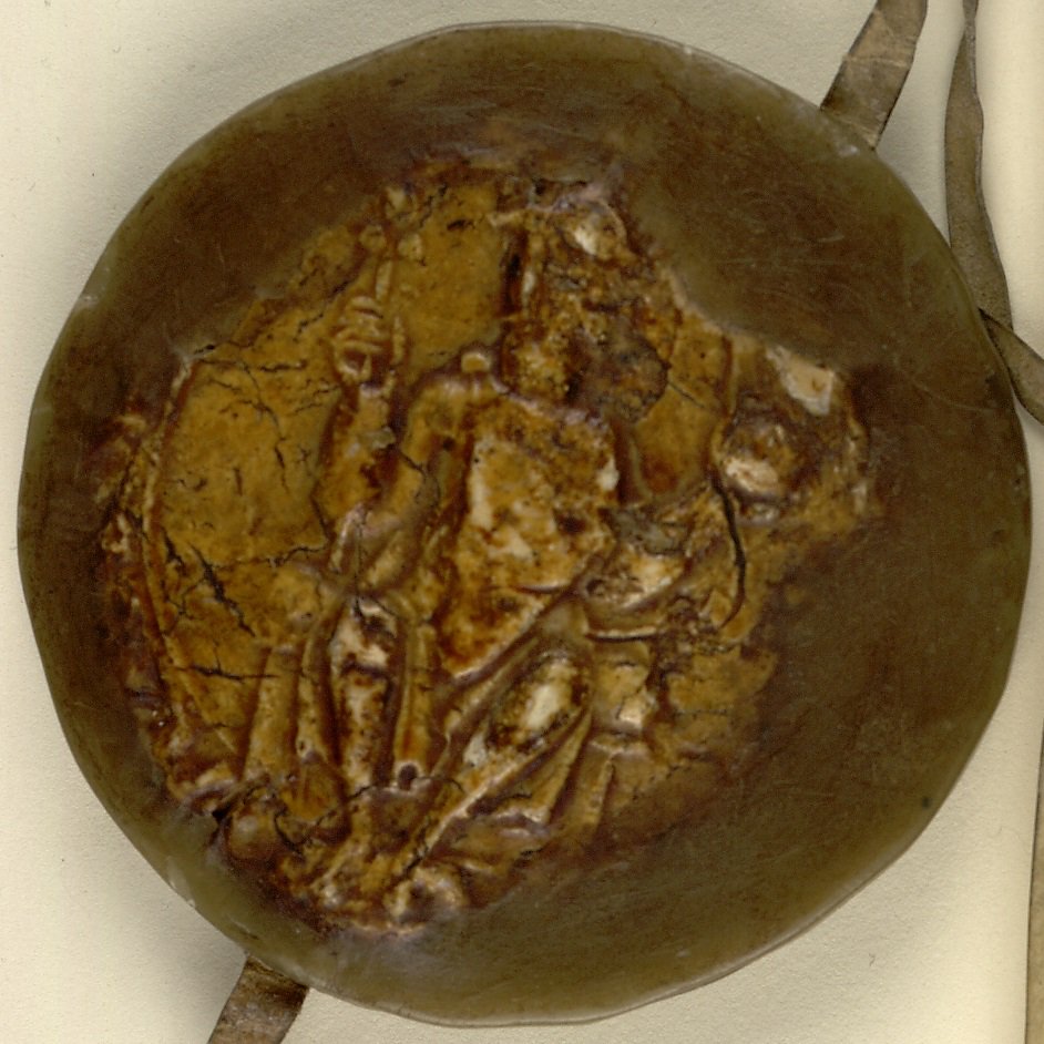 Yellow wax seal depicting a seated man holding a staff of office and an orb. LFC Ch xxi 5