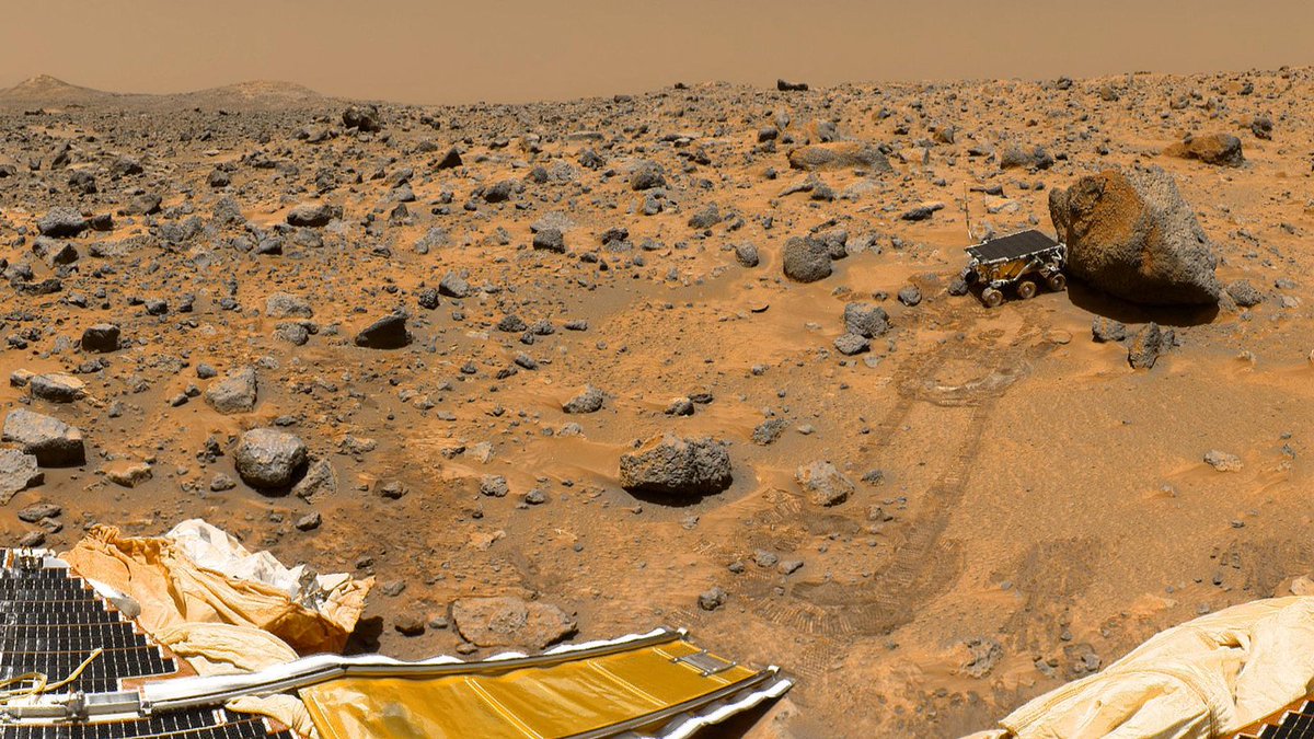 MarsExplorerWeb's tweet image. This portion of a classic 1997 panorama from the IMP camera on the mast  of NASA's Mars Pathfinder lander includes "Twin Peaks" on the horizon,  and the Sojourner rover next to a rock called "Yogi." Image credit:  NASA/JPL.