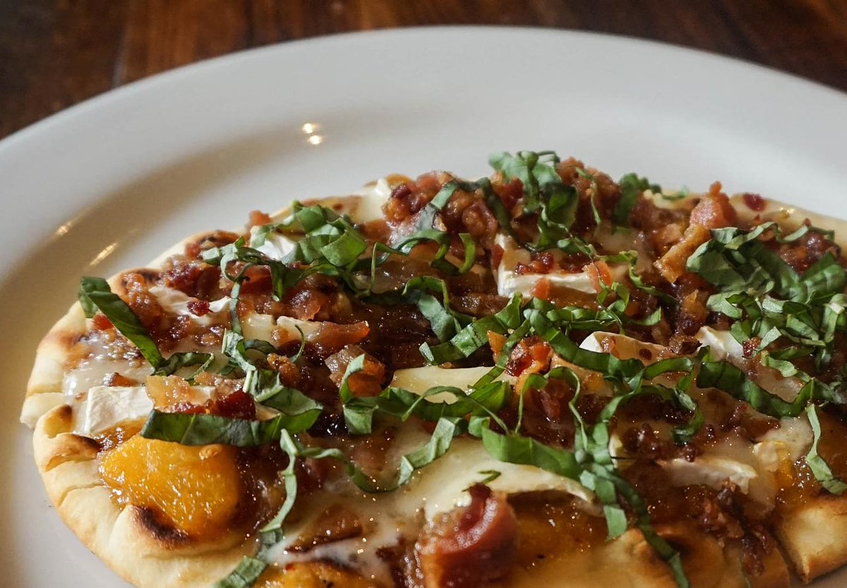 ArtisansTable's tweet photo. We have a delicious new flatbread on our dinner menu! It has a peach and caramelized onion compote, brie, bacon and basil. Yum! https://t.co/2wrJrhz2c9
