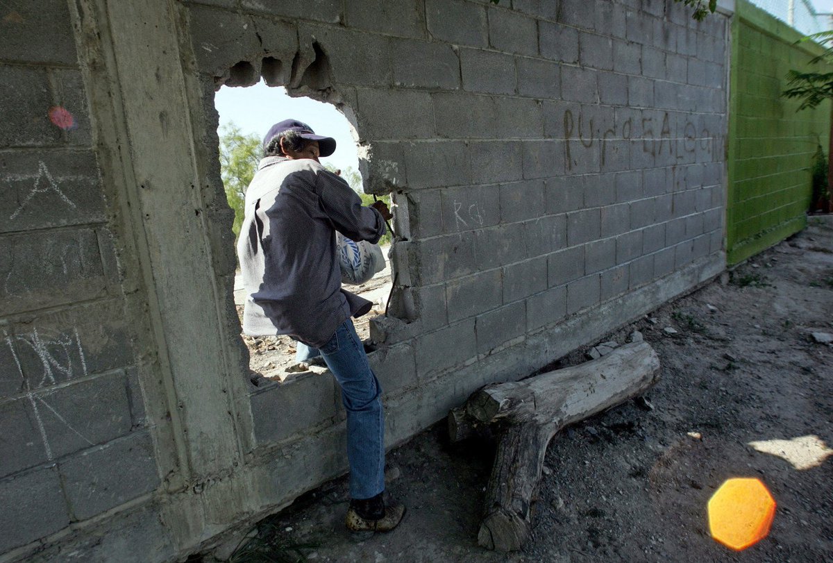 smashing or cutting a hole through the wall and stepping through.