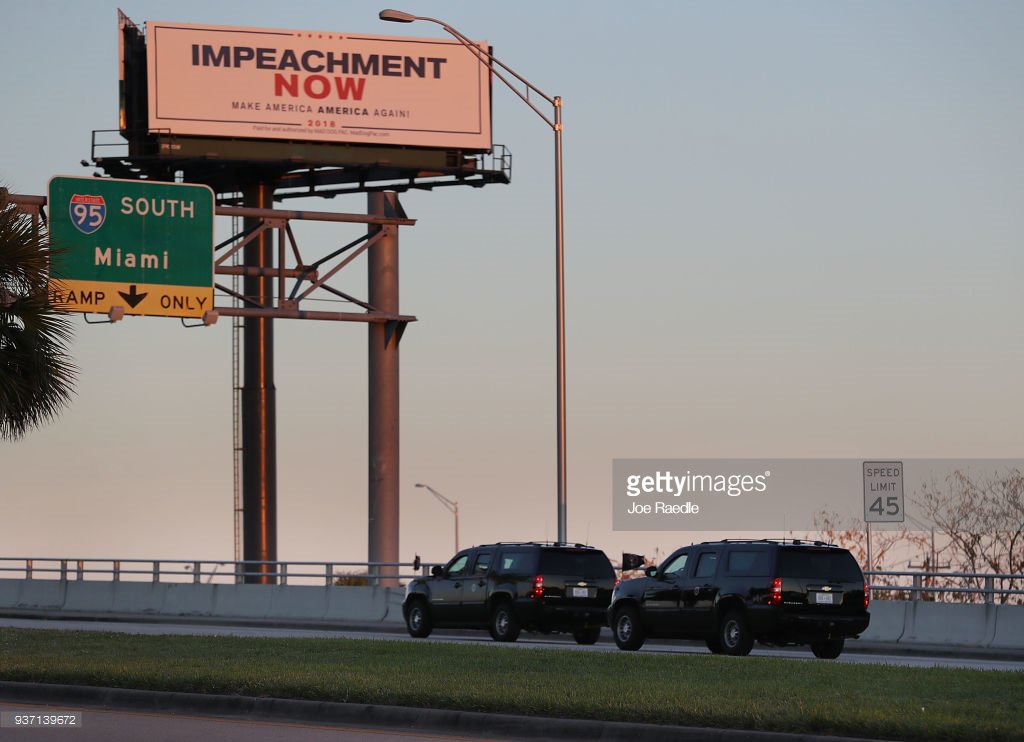 Vehicles from the motorcade carrying President Donald Trump pass a billboard calling for impeachment on the way to Mar-A-Lago this evening. 📷: @jraedle