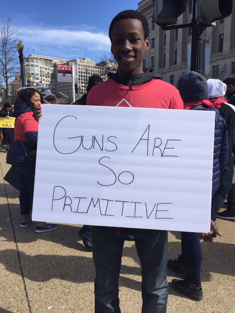 washingtonpost's tweet photo. Signs from the March for Our Lives: "I'm a teacher, not a sharpshooter."  https://t.co/hKyqSCyL1r https://t.co/txhcC1Pn5L