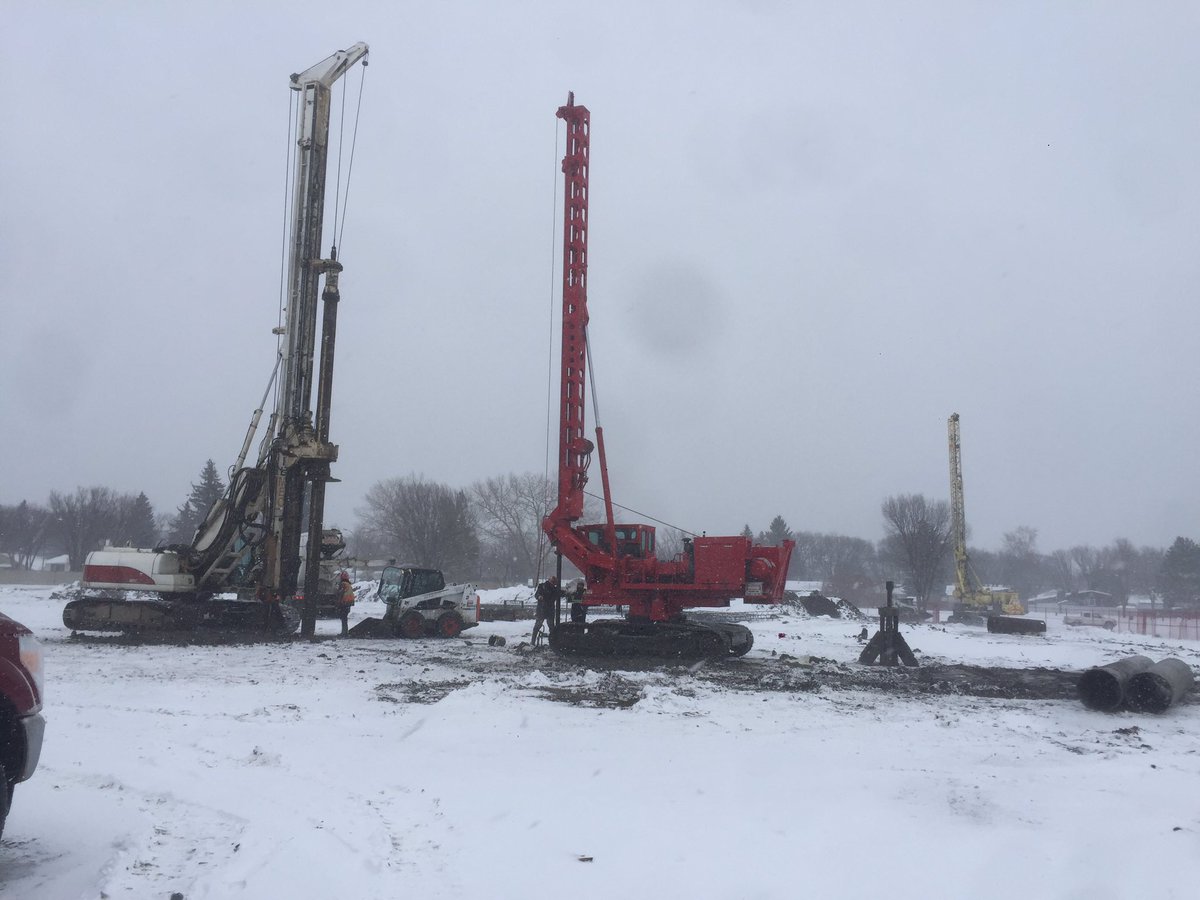 SaskPiling's tweet photo. Just more Canadian problems! What a difference 24 hours makes for the track attack, but 10cm of snow won't slow down our cased belled pile installation at the new #gordiehowe training facility! #stillaheadofschedule #spring? #notuntilmay #Saskatchewan #yxe @PilingCanada https://t.co/3DTfCXXv6f
