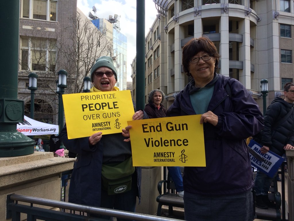 AmnestyWest's tweet photo. Amnesty International #EndGunViolence signs were so high in demand at the rally and march in Oakland I had to go back to the office three blocks away to print out more. 140 distributed in a few hot minutes. Let’s keep the momentum going! #MarchForOurLives #NeverAgain https://t.co/u3ewi9FCqq