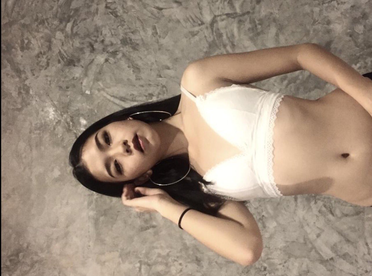 A woman's arm gripped in pleasure her skin flushed