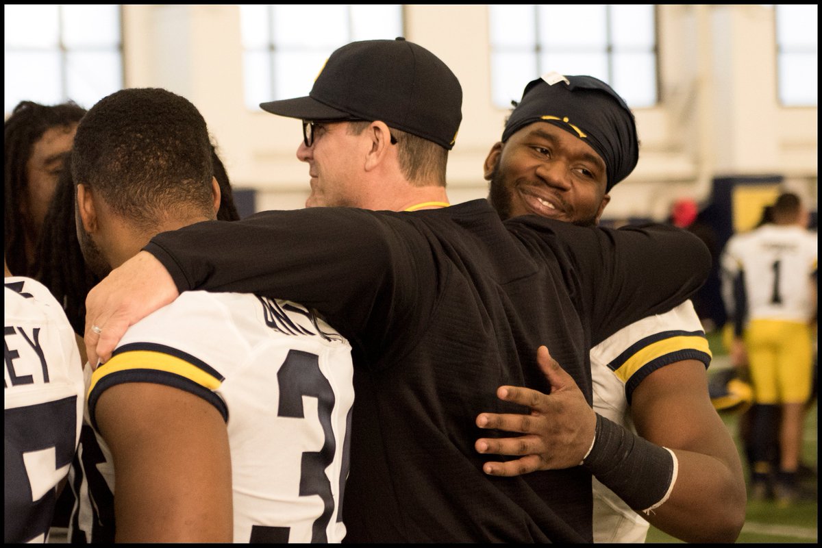 Coach Jim Harbaugh and his Team. On the the first day of the University of Michigan Spring Practice for the 2018 Season, Coach Jim Harbaugh, and linebackers Jordan Anthony, and Drew Singleton put their arms around each other at the end of a great first practice. ©David Turnley