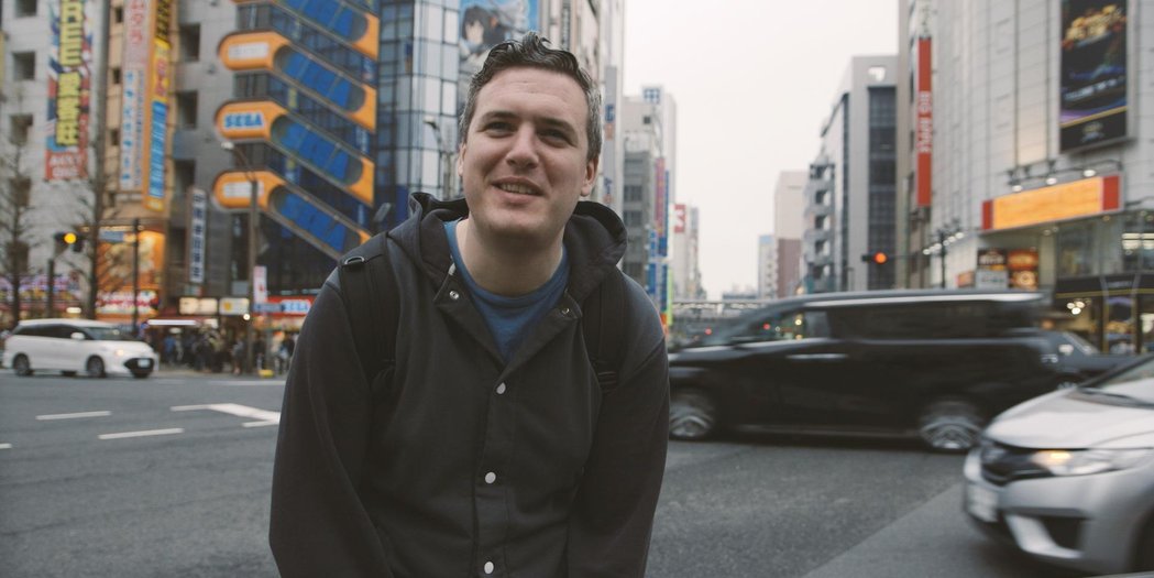 Noclip Founder Danny O Dwyer standing beside a busy junction in Tokyo, Japan