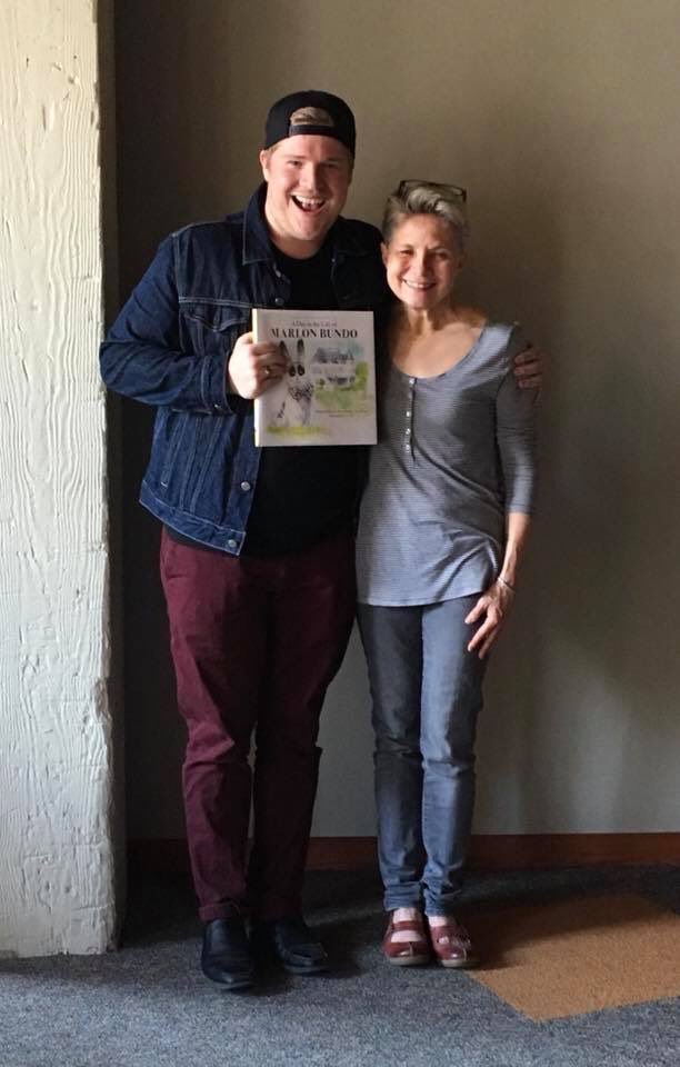 susankwalker's tweet photo. So proud to gift the Twin Cities Gay Men’s Chorus with a copy of A Day in the Life of Marlon Bundo signed by the TC women’s choir after joining them for 2 concerts on Rising Up for justice! #MarlonBundoBook #tcgmc #tcwc #RiseUp https://t.co/7YrEVOvc7p
