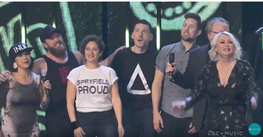 HaydnWatters's tweet photo. Spryfield, Nova Scotia got a whole lot love on the national stage tonight. Gina Burgess of The Jerry Cans was sporting a Spryfield Proud t-shirt while on stage during the big Barenaked Ladies finale. @CBCNS https://t.co/SjYsDGQFIg