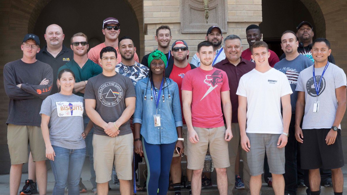 Group of veterans standing together in front of the Academic Building