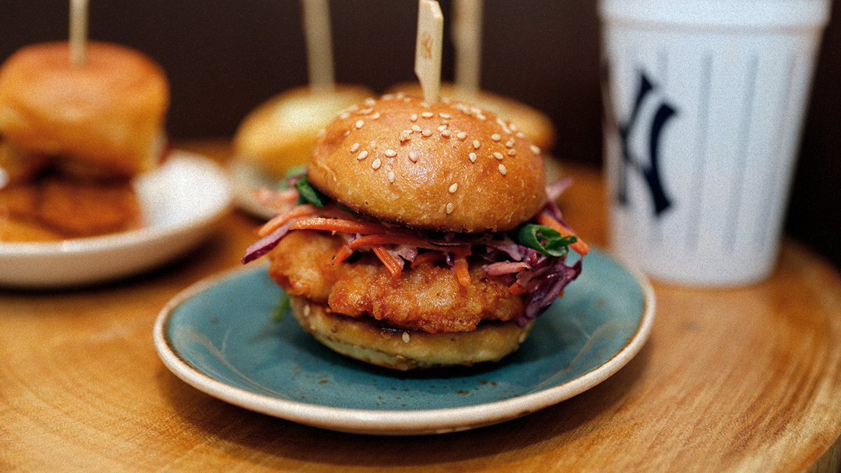 Yankees's tweet photo. #YankeeStadiYUM has lots of new offerings:

🍺 @BluePointBrewer Pinstripe Pilsner
🍦Grand Slam Milkshakes
🍗 General Tso's Crispy Chicken Sandwich
🍍 @KingsHawaiian Original Sweet Pineapple BBQ Kalua Pork Nachos

AND MUCH MORE. Here's the full 2018 menu: https://t.co/sfOLCqDltv https://t.co/k6iqgbixuQ