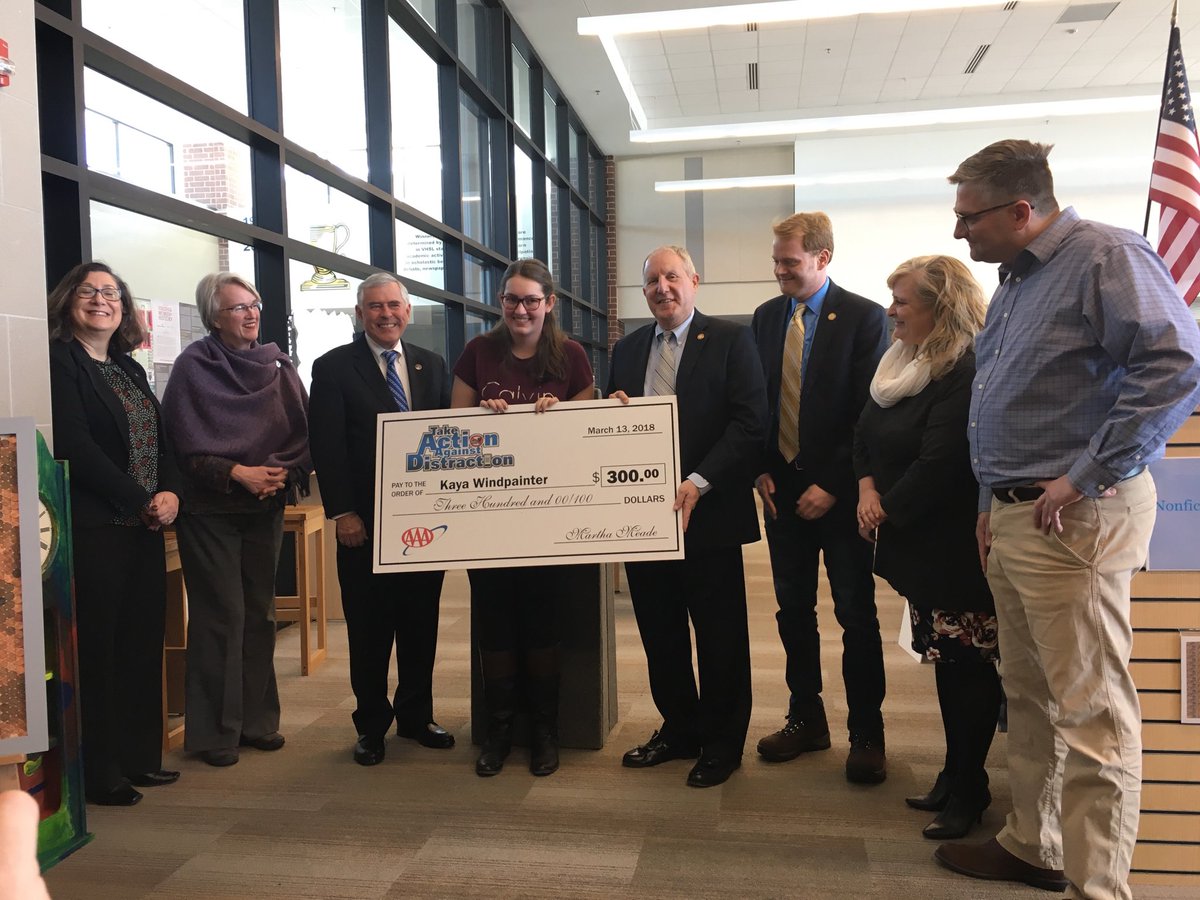 DweaverRick's tweet photo. DMV Commissioner Rick Holcomb presents $300 to Kaya Windpainter, BHS Graphics Arts student at BHS. Kaya’s license plate design won Roanoke District competition. Next up State Competition. https://t.co/hTps9kdbkJ