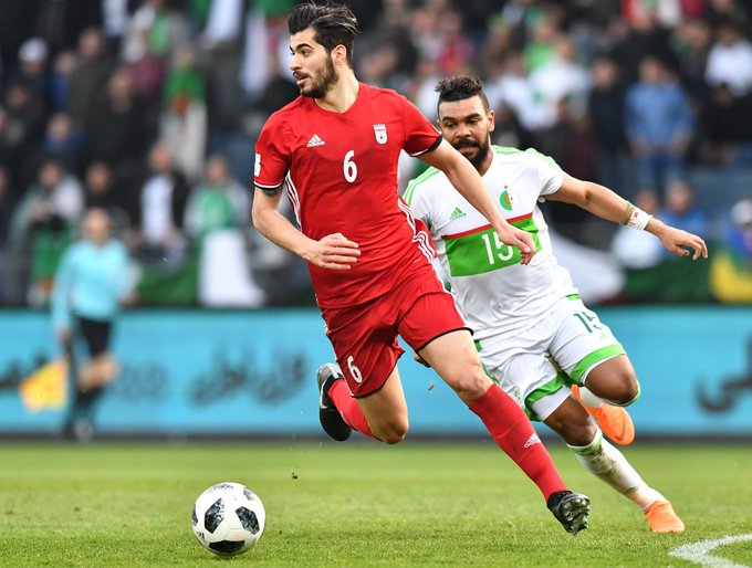 Iran's midfielder Saeid Ezatolahi (L) and Algeria's Hillel El Arbi Soudani vie for the ball during the international friendly football match between Iran and Algeria.