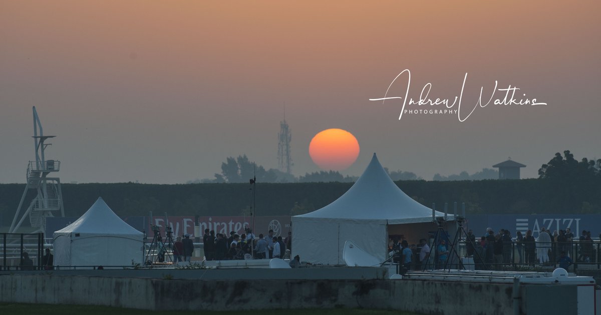 The sun rises at Meydan as the media enjoy coffee and pastries during the track harrow break.