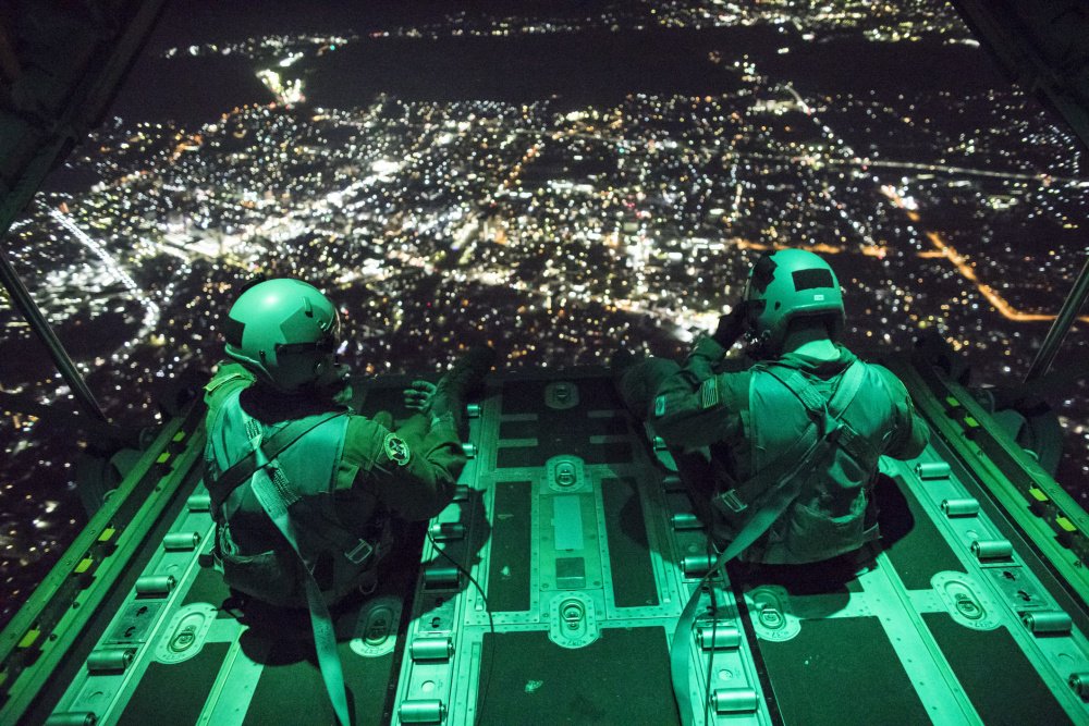 FoxNews's tweet photo. Senior Airman Stephen Clark and Airman 1st Class Matthew Pfeffer sit on the open ramp of a C-130J Super Hercules flying near Yokota Air Base in Japan. https://t.co/867NkG1K7k