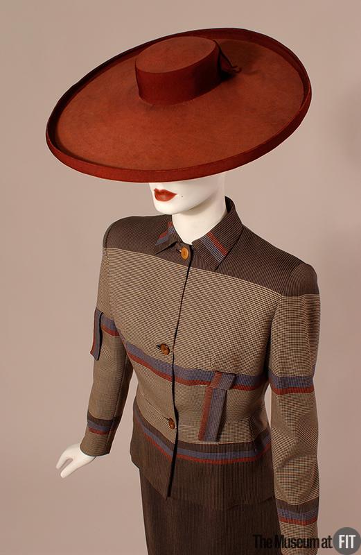 Suited Up Week: This c.1946 day suit is instantly recognizable as an #Adrian creation. He was unsurpassed in his ability to seam and piece fabrics. His subtle use of color was no doubt honed during his years as a costume designer for films.  Via #MuseumatFIT #GilbertAdrian