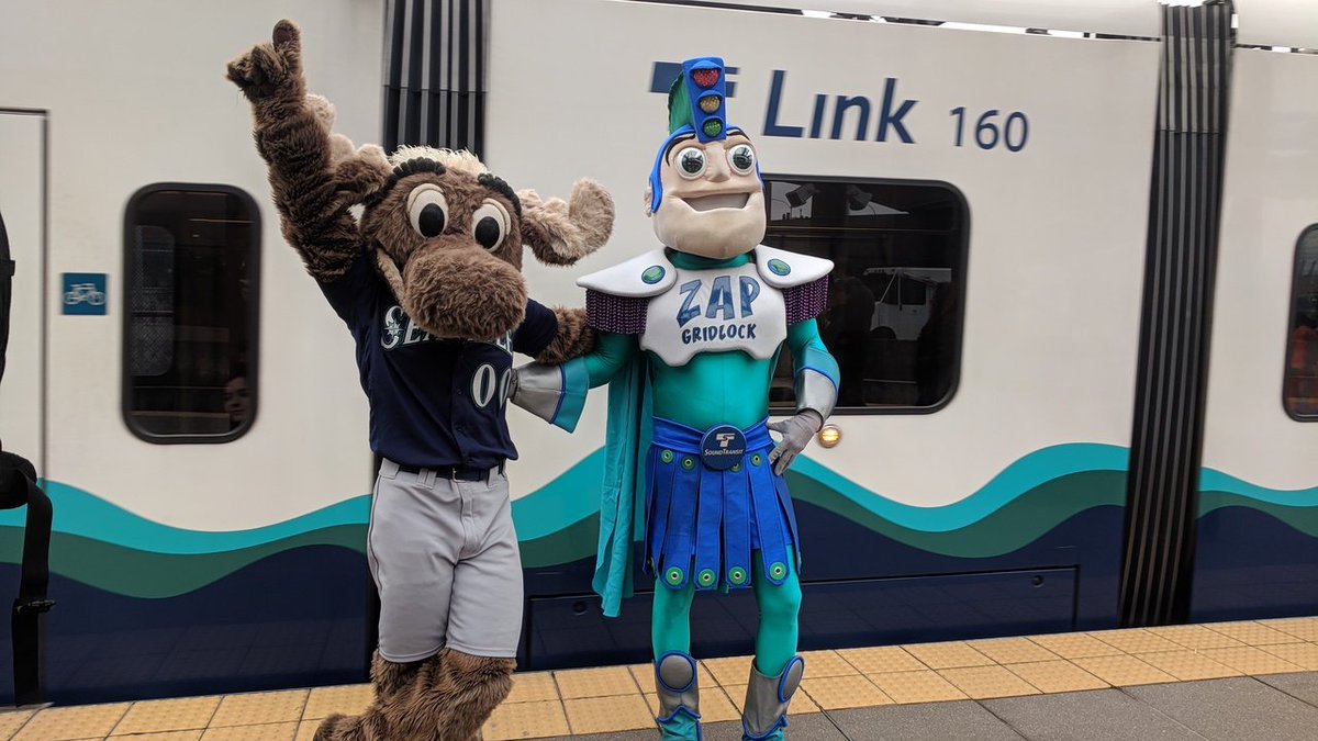 Mariners Moose and Zap Gridlock celebrate taking the train to the game.