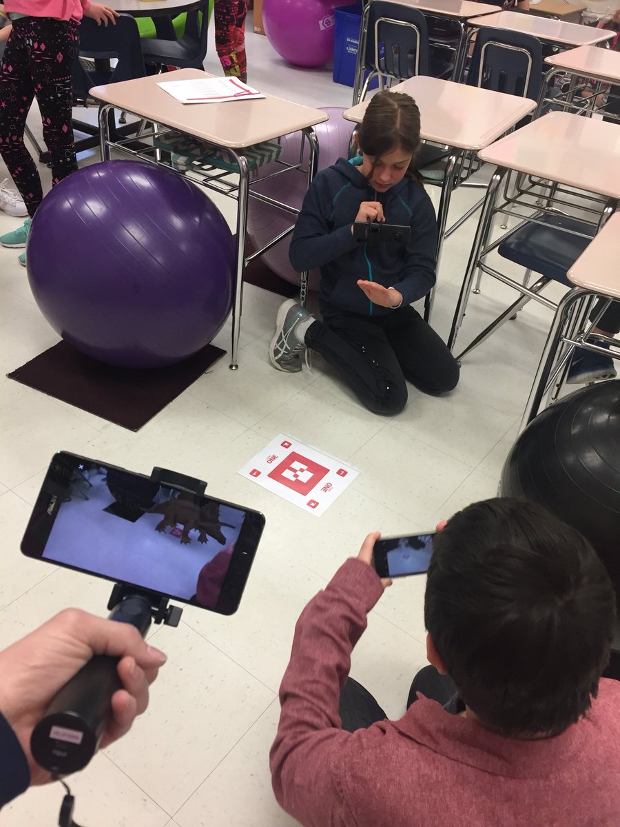 A student is trying to take a pic of the augmented reality dinosaur!  Sorry, he won’t appear in the picture because he can only be seen on the phone. 
<a href="/crestviewmiddle/">Crestview Middle</a> #cmsleads #GoogleExpeditions #GoogleARExpeditions #wearerockwood
<a href="/stretchgriswold/">Linda Griswold</a>