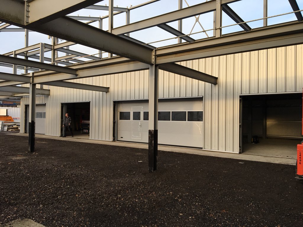 IPLimited's tweet image. So what can you do with an old steel frame, that has sat dormant for quite a few years, on land where you store cars.  Why not build a new 5 bay, valet bay and make the most of the space.  Audi Southend have taken that option, with some careful detailing around columns &amp;amp; beams