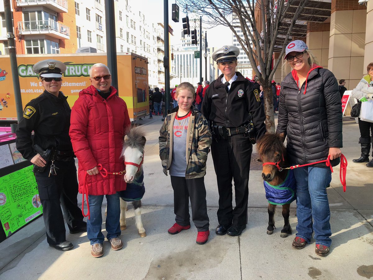 CincyPD's tweet photo. Officers Kristy Collins of @HamiltonOhioPD, Renee Lutterbie of Ross Township &amp; Roberta Utecht of @CincyPD  join Lisa Moad &amp; her Valor Program @ittybittyhorses to say #WhoaToBullying @Reds #KidsOpeningDay. https://t.co/UgSjPKkh7Z
