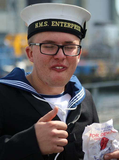 Our young sailor, again, dressed in number ones, and eating a Ivor Dewdney pasty. Perhaps his eyes are closed because he is enjoying the taste of Plymouth!