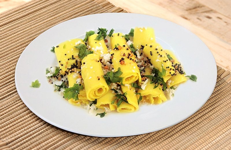 Khandvi, also known as Patuli, Dahivadi or Suralichi Vadi, is a savory snack in Maharashtrian cuisine as well as in Gujarati cuisine. It consists of yellowish, tightly rolled bite-sized pieces and is primarily made of gram flour and yogurt. aapnarecipe.in/recipe/khandvi