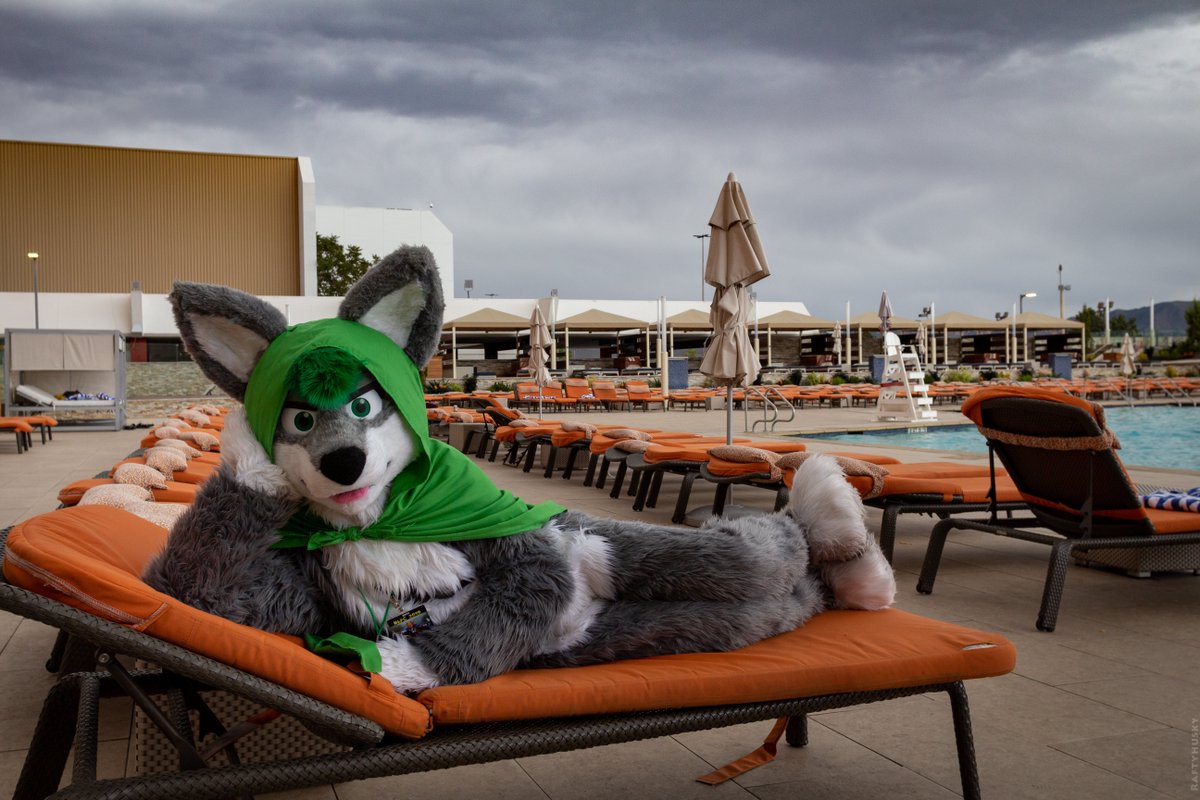 Fylwind lies on a lounge chair near a swimming pool, giving the audience a condescending glare