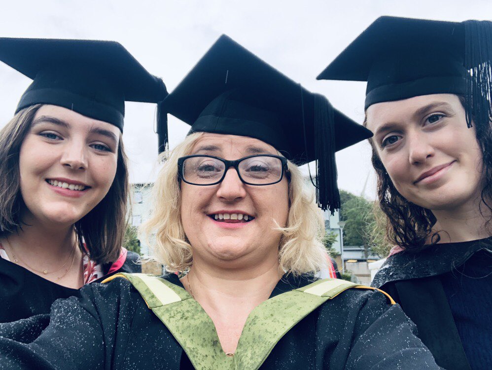 Three women in graduation gowns.