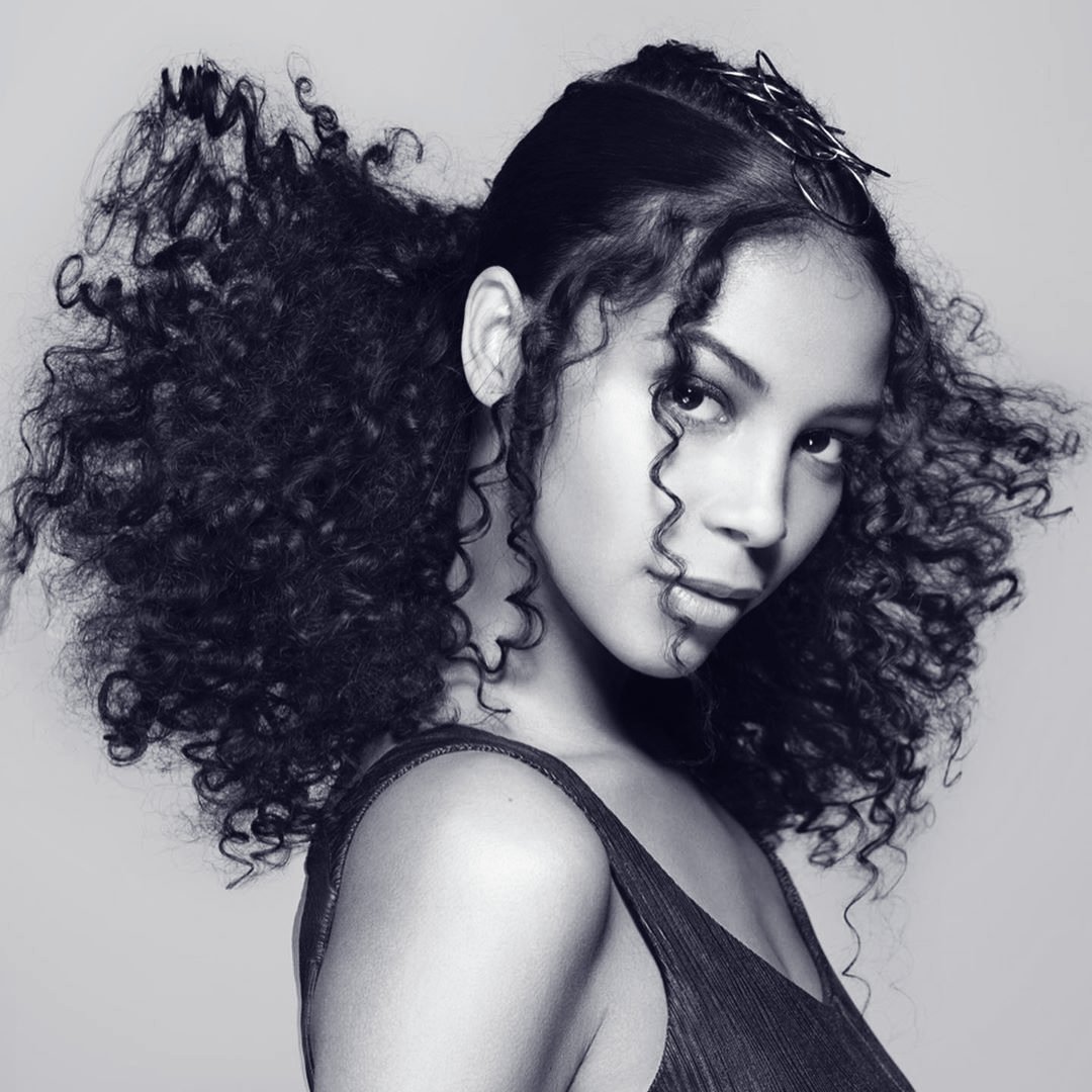 Strike a pose. We love this look from Leo Valencia who used Whipped Crème to condition hair and create soft, bouncy curls. He used a pick on the base of her hair and disrupted some curls using a blousing #technique. #IAMWHATSNEXT #ShapeYourWorld