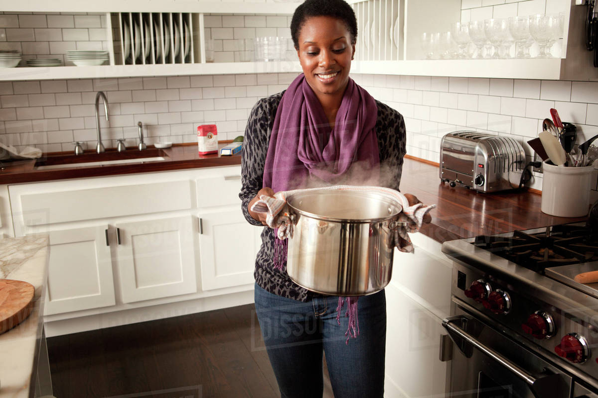 “She opened the boiling pot as it let out a fume of sweet smelling steam on...