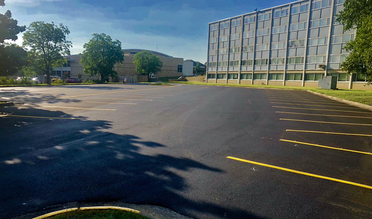 Second phase of Arkansas Hall parking makeover complete with new layer of pavement/fresh striping. Potholes and concrete islands are gone!
