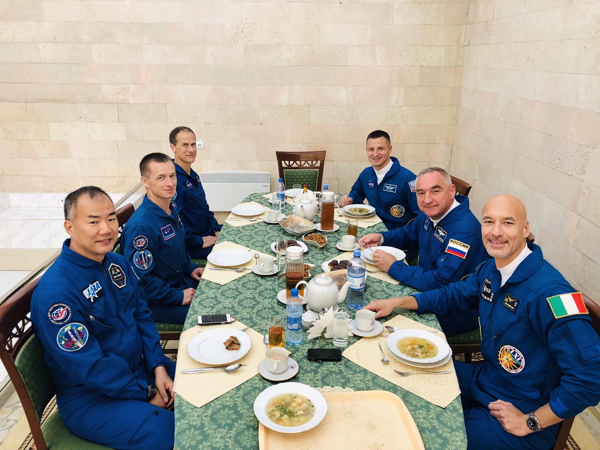 Astro_Soichi's tweet photo. Expedition 60 astronauts @AstroDrewMorgan, @astro_luca, and cosmonaut Alexander Skvortsov, your next meal will be spacefood! Final lunch at #Baikonur プライムとバックアップで囲む最後のランチ。打ち上げクルーはこの後発射台へ！ https://t.co/Np3zAfHd9i