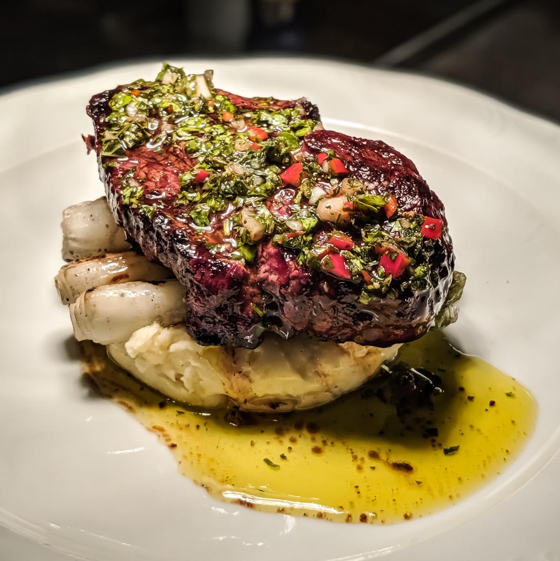 Filet Mignon from Creekstone Farms. Wood grilled, served over Yukon Gold Potato Purée, Grilled Local Spring Onion, Chimichurri