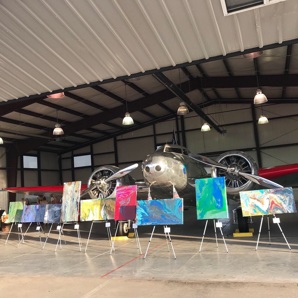 AEHangarMuseum's tweet photo. #Muriel with Aerial Abstracts, an eighteen-piece collection of original paintings created by @ameliarosefield that commemorate her world flight in 2014. Each canvas represents a leg of her long journey in a single-engine plane. #VisitAtchison #art #AEF19 #ameliaearhart https://t.co/Ks1Emly7z8