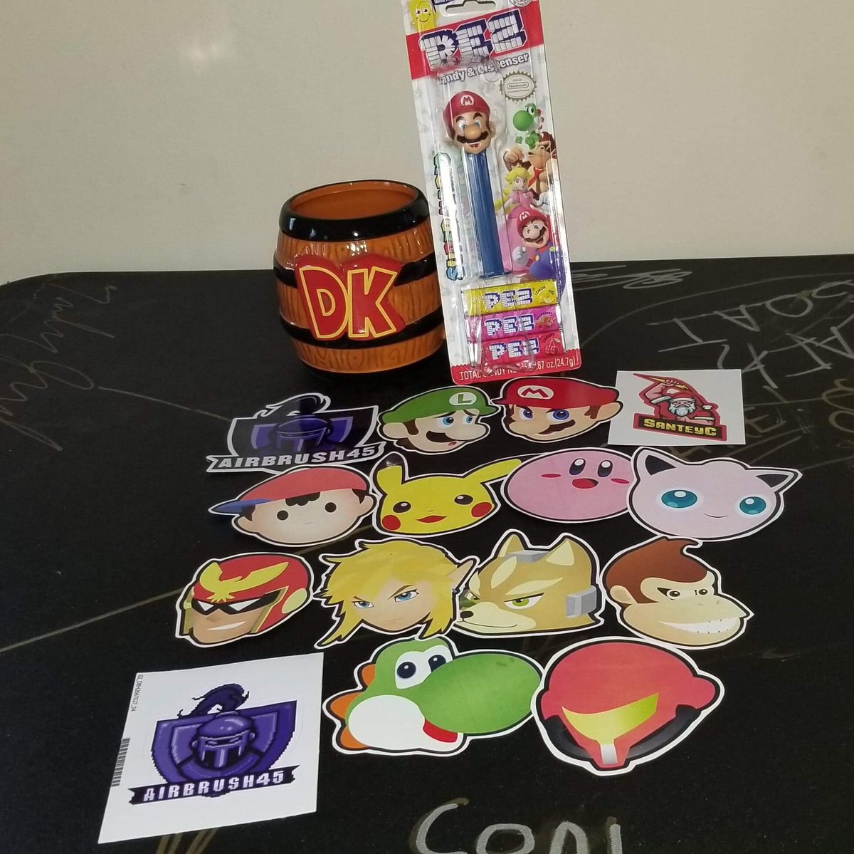 AirBrush45's tweet photo. Today is finally the day!! RETRO REWIND STARTS TODAY AT 3pm EST!! Let’s go over all of the prizes! Starting with the Sticker pack! Stickers for all Original Smash characters, AirBrush45 and SanteyC Donkey Kong barrel mug, and Mario Pez dispenser! https://t.co/knKPq8e8NF